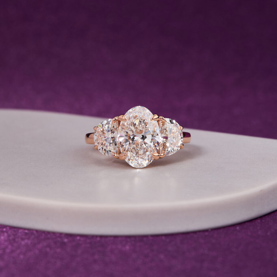 3.00 CT Oval-Cut Diamond, gracefully complemented by two exquisite 1.00 CT Half-Moon Diamonds Ring