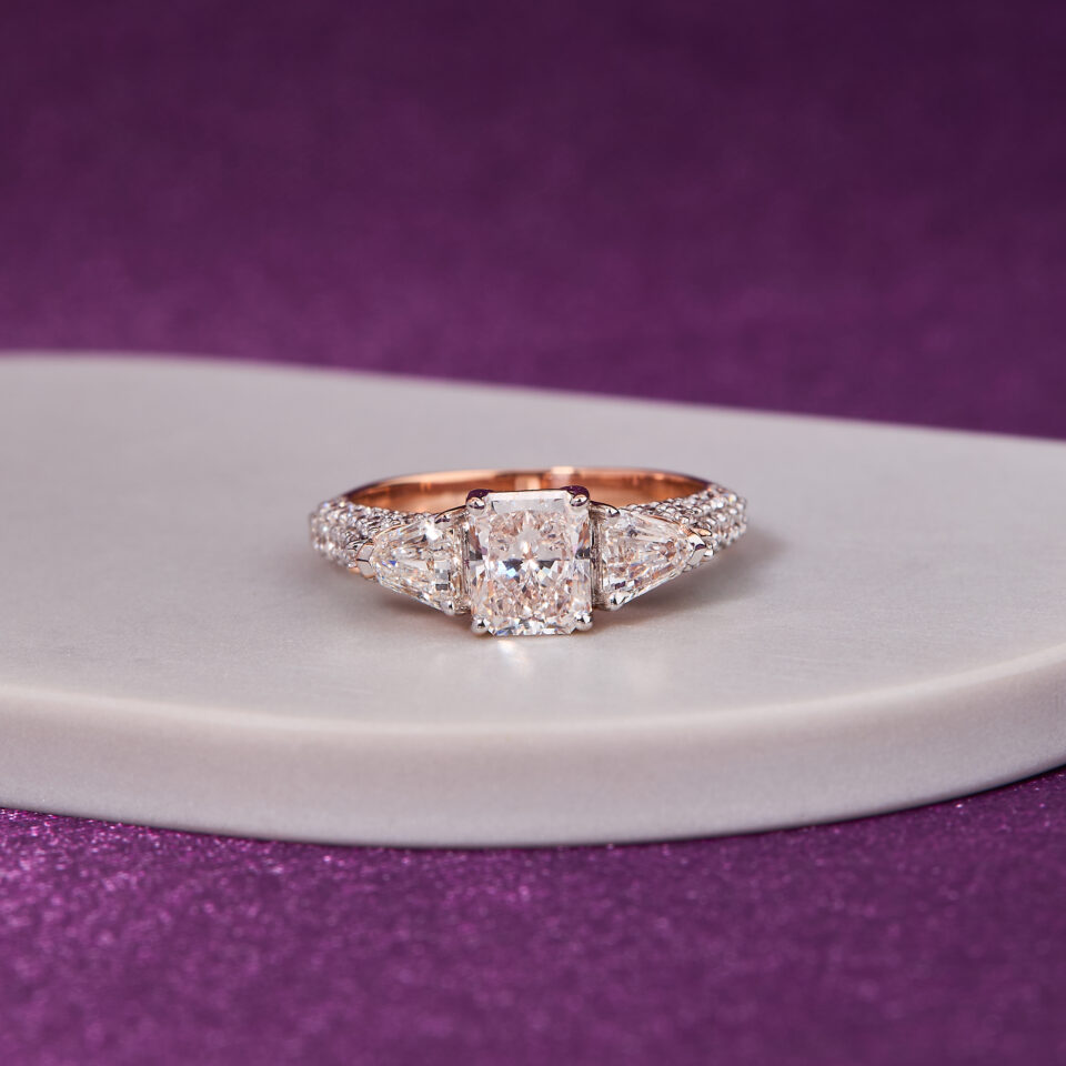 1.20 CT Radiant-Cut Diamond, complemented by two exquisite 0.75 CT Trillion-Cut Diamond ring